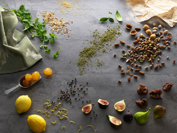 Fresh fruits and veggies are spread out across the table.