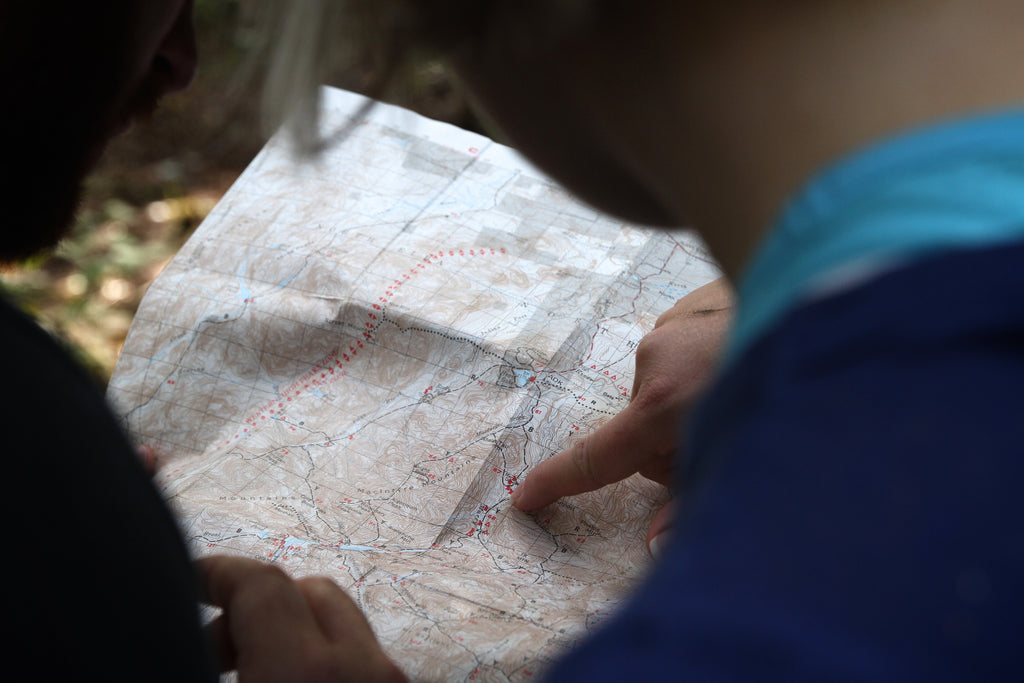 Two runners are reading a map.