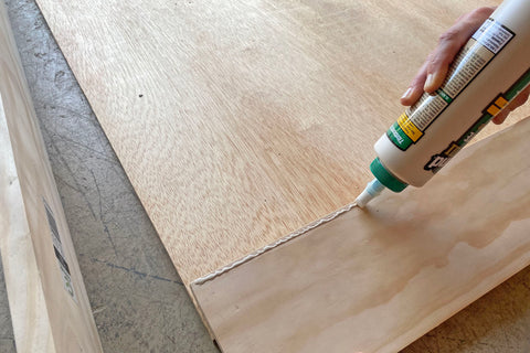 applying wood glue to diy hairpin legs dog bed