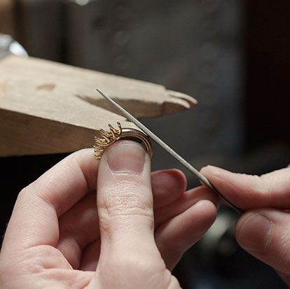 Chris Ritchie filing jewelry ring.