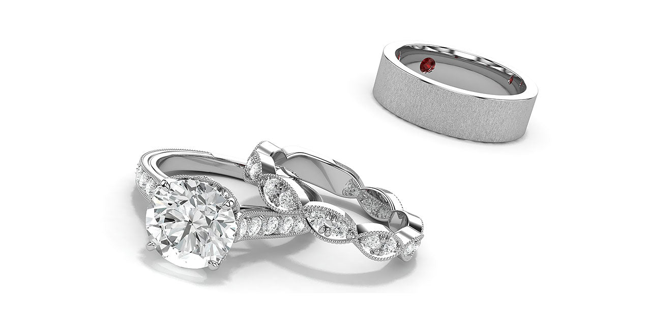 A platinum and diamond engagement ring and wedding band using lotus flower petal shapes and hidden birthstones.