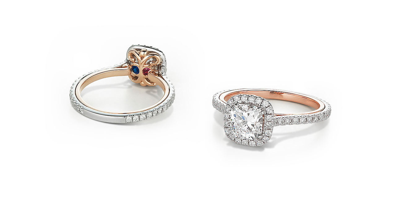 Photographs of the top and underside of an open scroll two-tone engagement ring set with diamonds and birthstones.