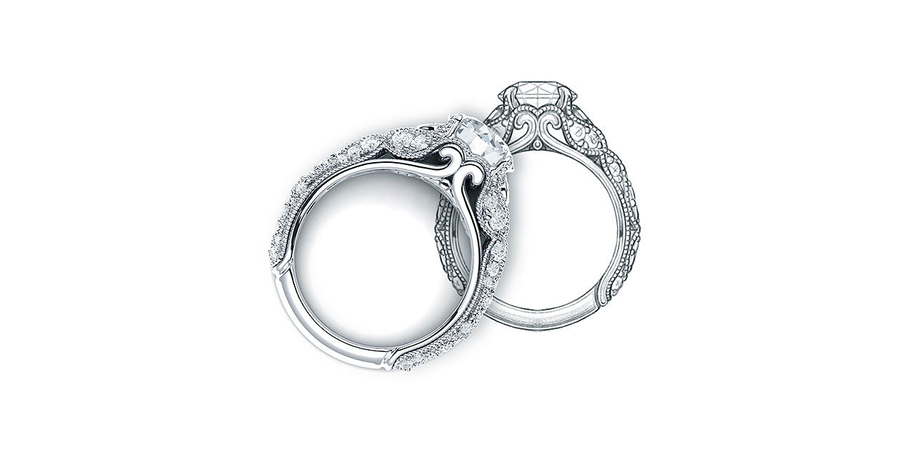 A vintage style diamond engagement ring with leaf and petal inspired shapes forming the sides of the ring, laying on the original drawing of the ring.