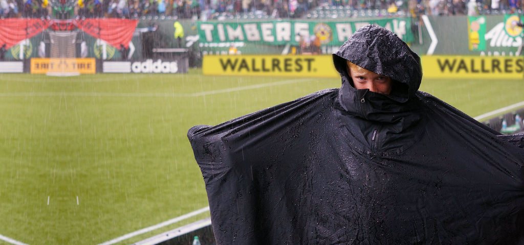 Happy Portland Timbers fan watching a Timber's match while wearing a Wallrest