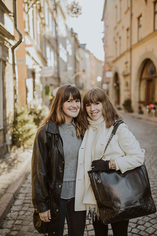 Katie and Lisa of Dressing Vintage on the street in Gamla Stan in Stockholm, Sweden