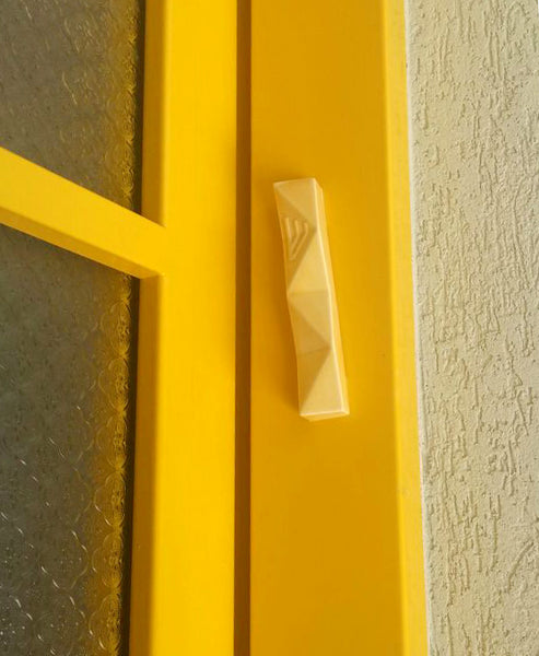 Yellow Mezuzah case, on a Yellow doorpost, daring and bright, a unique entrance to Ruthie's home in Mazkeret Batia