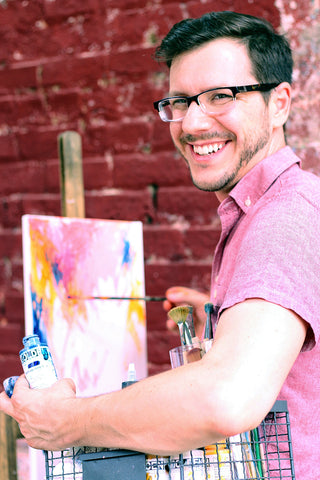 Stephen Lursen artist headshot while painting