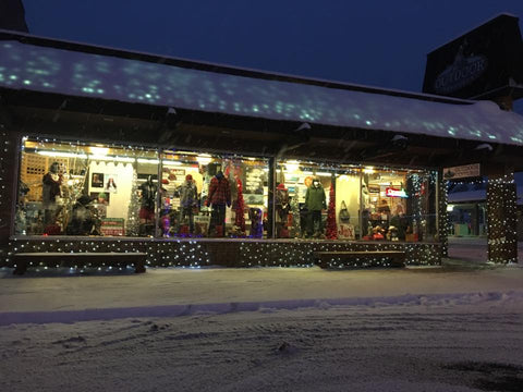 Outdoor Ventures - A Lure of Lights snow covered streets store front view