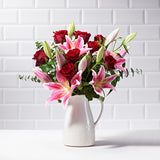 Paradise Postabloom bouquet | pink lilies and red roses delivery