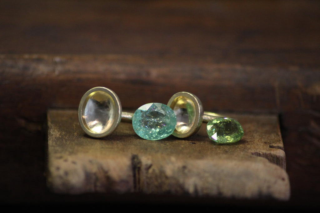 Paraiba tourmaline rings on the workbench, about to be set in Julia Lloyd George London studio
