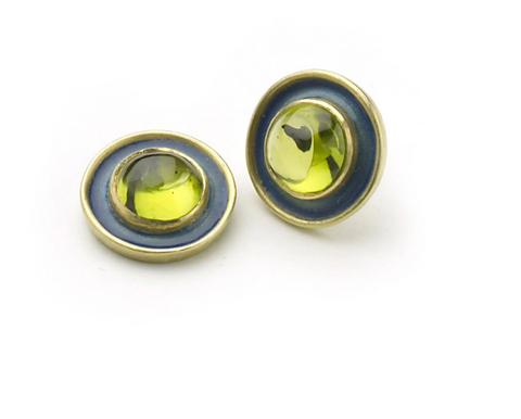 Yellow gold stud earrings set with peridot cabochons with blue enamel borders