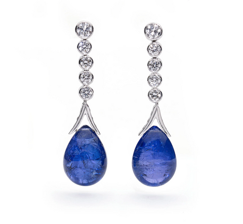 Statement white gold drop earrings set with round cut brilliant diamonds, with large pear shaped tanzanite cabochon drops