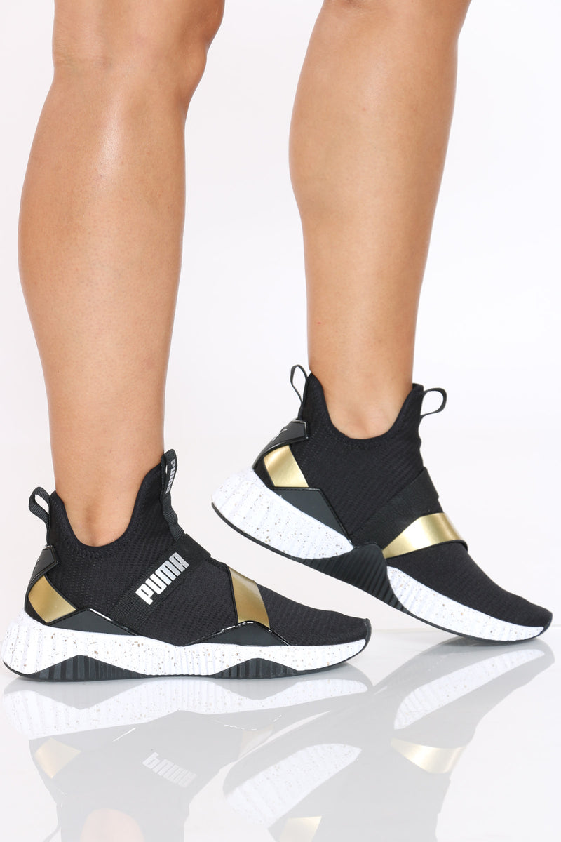 puma defy mid black and gold