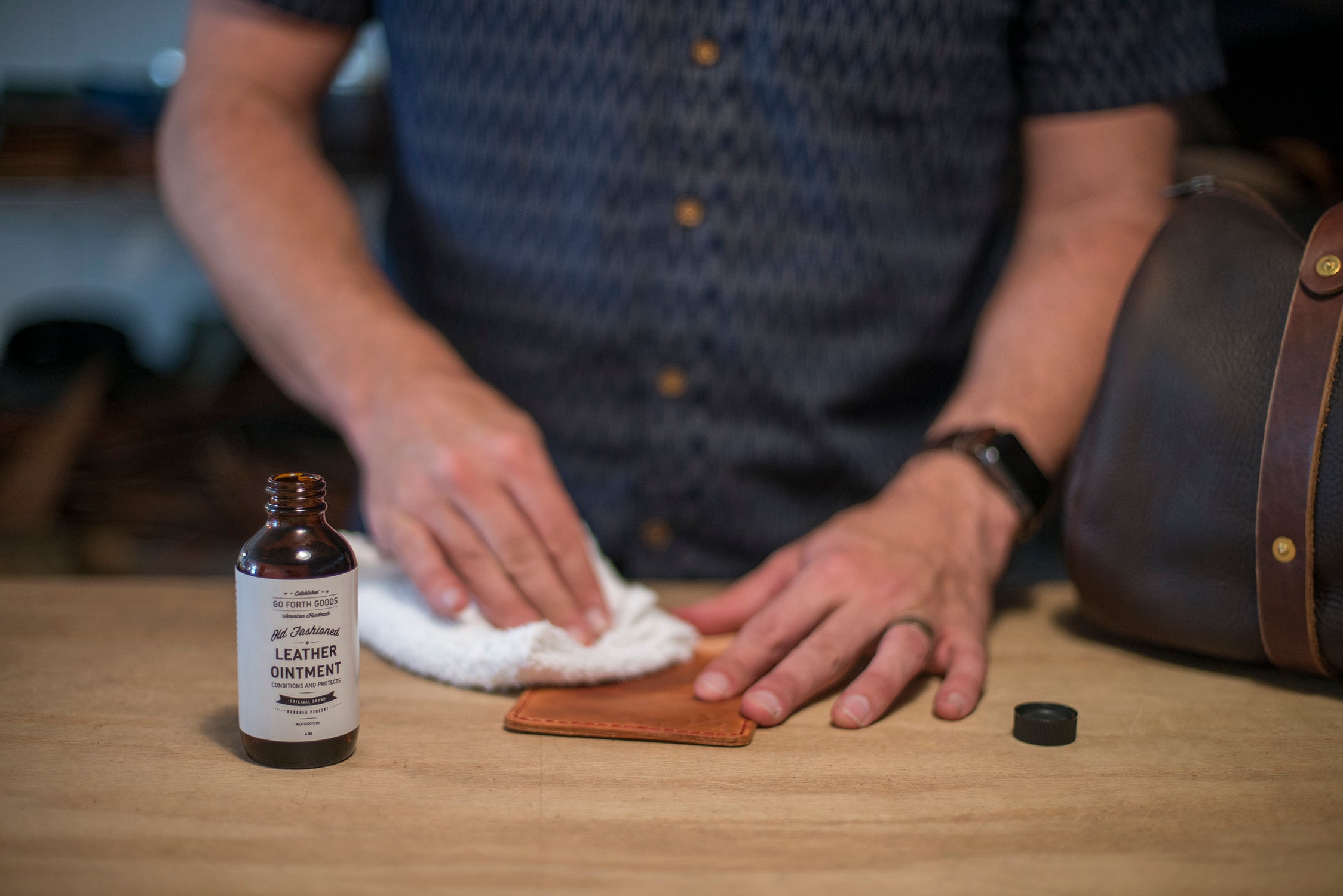 Rub oil evenly into leather. 