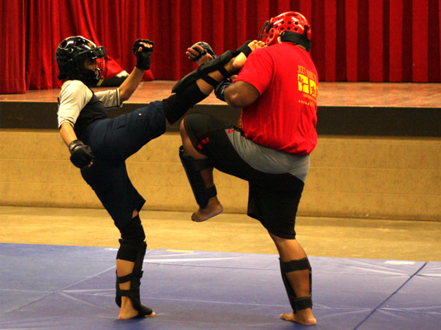 Photo of Sarah Badat Richardson throwing a high kick to the head