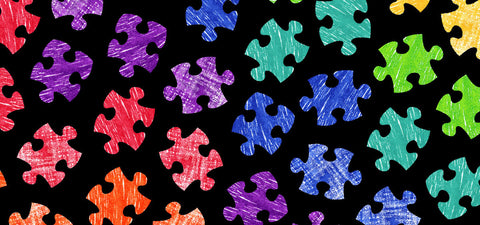 Autism rainbow puzzle pieces on black background for awareness and acceptance