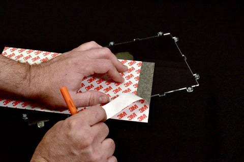 Peel a 1" strip from adhesive film