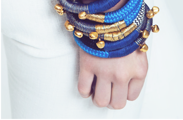 Close up of woman wearing multiple summer rope bracelets