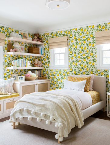 A childs room with busy lemon wall paper
