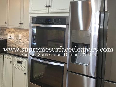 Stainless steel appliances built into cabinets with a black granite countertop.