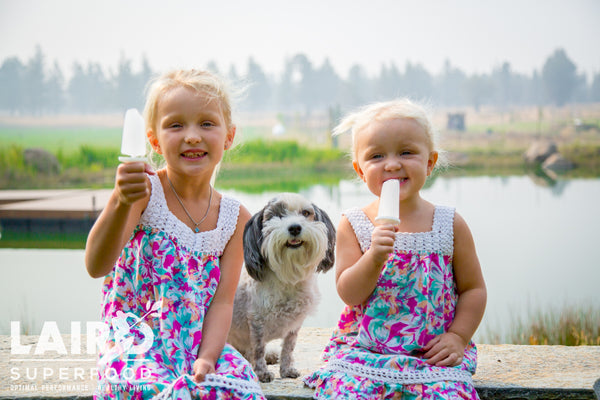 Girls with popsicles and dog