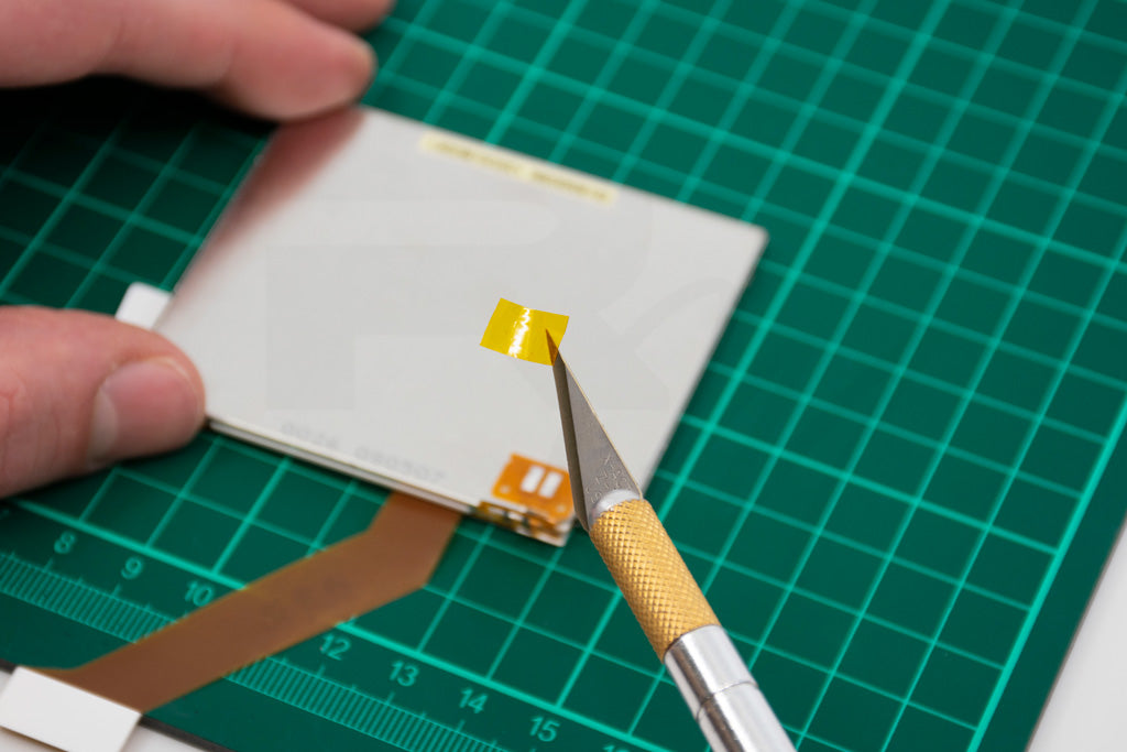 Apply a small piece of Kapton tape over the bottom ribbon