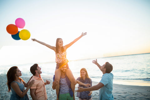 friends at beach with baloons in charlie mae swimwear