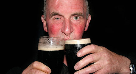 Man alcohol flushed drinking Guinness beer