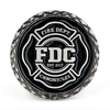 A black coin featuring Fire Department Coffee's maltese cross logo.