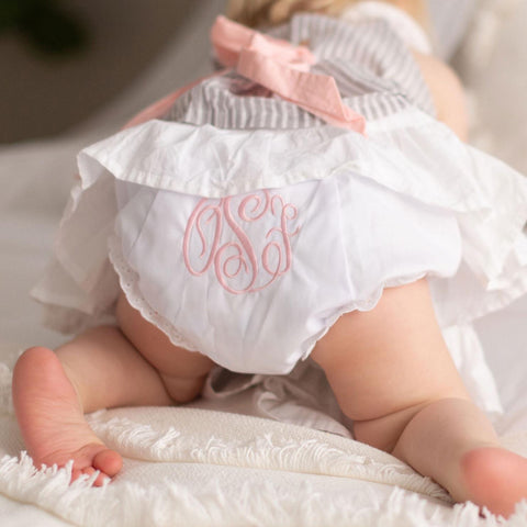 Baby's bottom wearing a monogrammed diaper cover