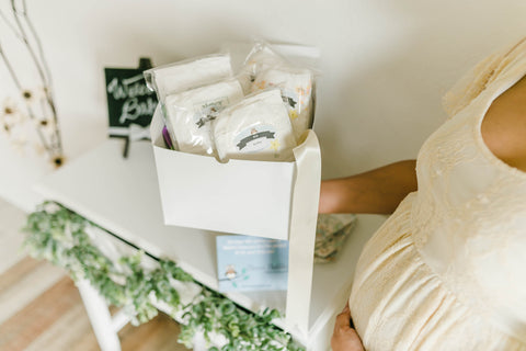 Pregnant mom holding Diaper Dabbler Diaper Sampler Package