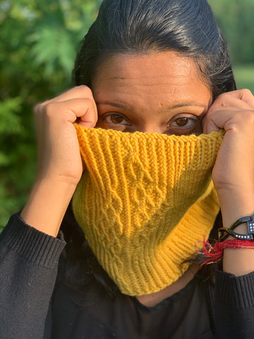 Indian woman models golden yellow knitted cowl 