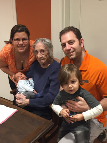 An old woman, Iris, surrounded by the young family of her granddaughter Marisa, her husband Andrew, and their children.