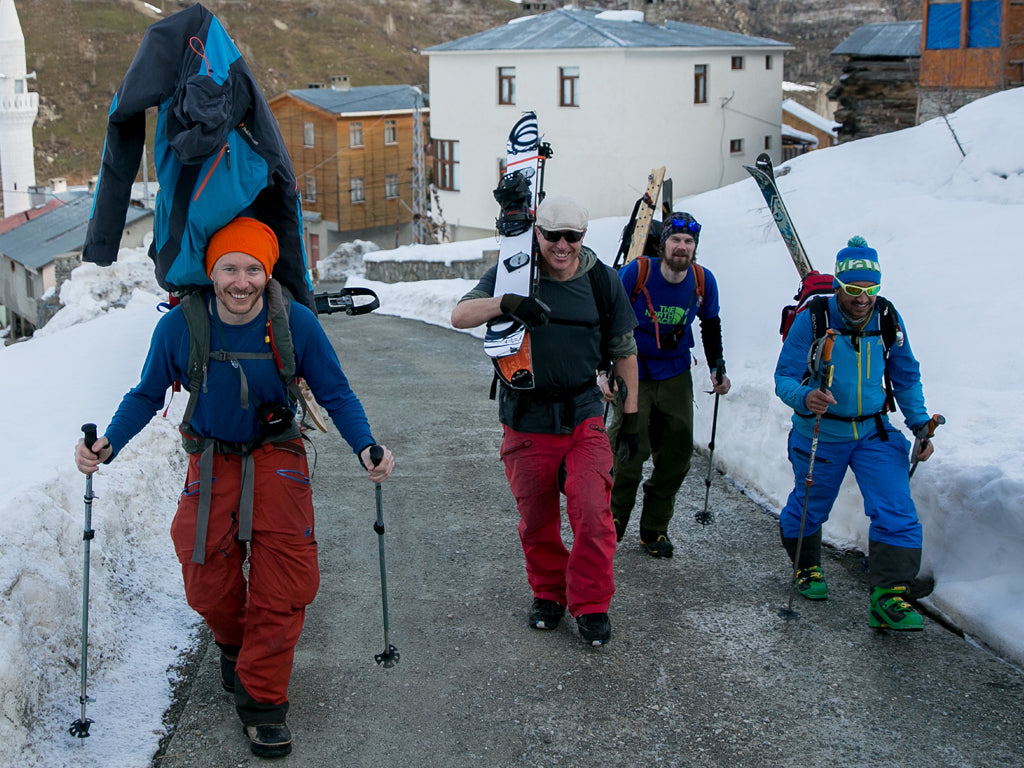 Venture Snowboards crew hiking out of town