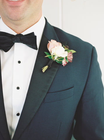 Boutonniere by Old Slate Farm, Black Silk Ribbon by The Lesser Bear Photo Henry Photography as seen in Martha Stewart Weddings