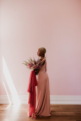 model in shaft of light with pink dress and silk ribbon by The Lesser Bear