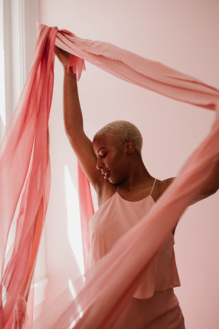 Model dancing with pink silk ribbon by the lesser bear