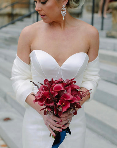 Bride holding cala lilies bouquet by Vessel Floral and Events with Navy Velvet Ribbon by The Lesser Bear STR Events and Photo by Kismet Visuals