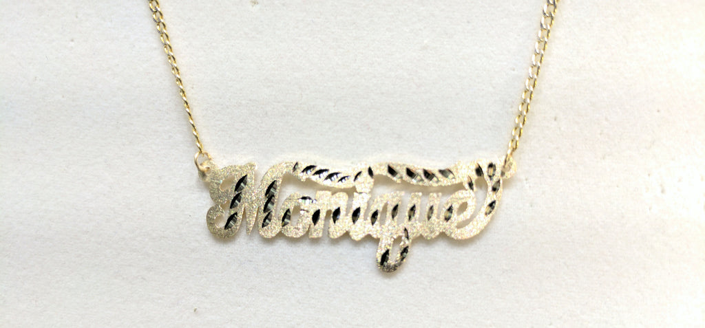 In the center: a custom made name plate two tone cuban link necklace for Monique in 14 karat yellow gold florentine finish and diamond cut tail design by Popular Jewelry