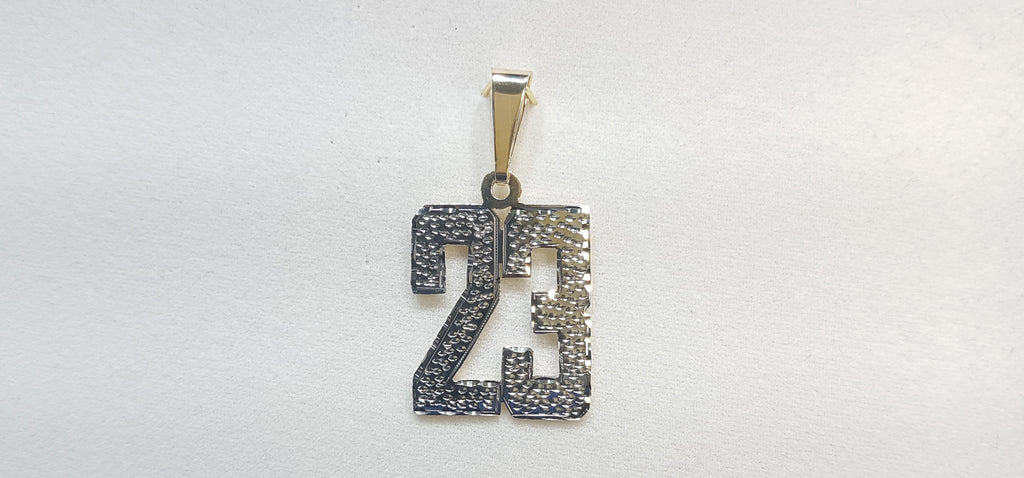 On the center: a custom made name plate number 23 in 14 karat yellow gold with white bead work finish on top - Popular Jewelry