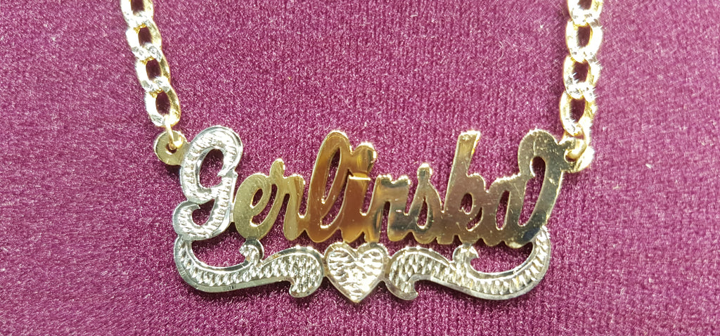 In the center: a custom made name plate cuban necklace for Gerlinska in 14 karat two tone yellow gold with high polish finish and white bead work and heart shaped tail made by Popular Jewelry