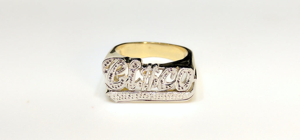 In the center: a custom made name ring for Francisco stylized "Ci$co" in 14 karat yellow gold with two tone high polish white bead work finish made by Popular Jewelry in New York City