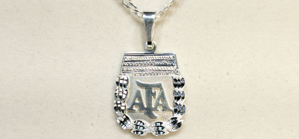 In the center: a custom made sterling silver pendant stylized Argentina Football / Futbol Association Crest made by Popular Jewelry in New York City