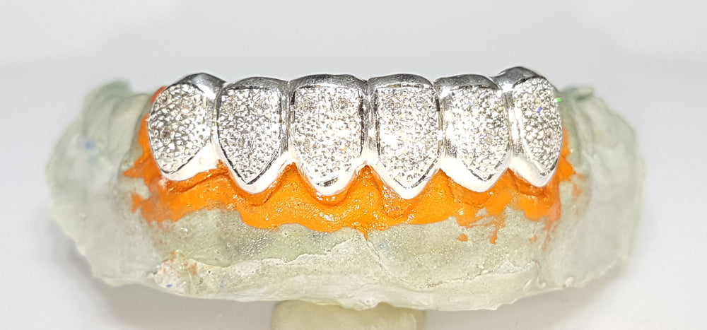 In the center: a custom made sterling silver teeth grill for Ricky who is a b-boy from Japan with white bead work cut finish and set with cubic zirconia gemstones - Popular Jewelry