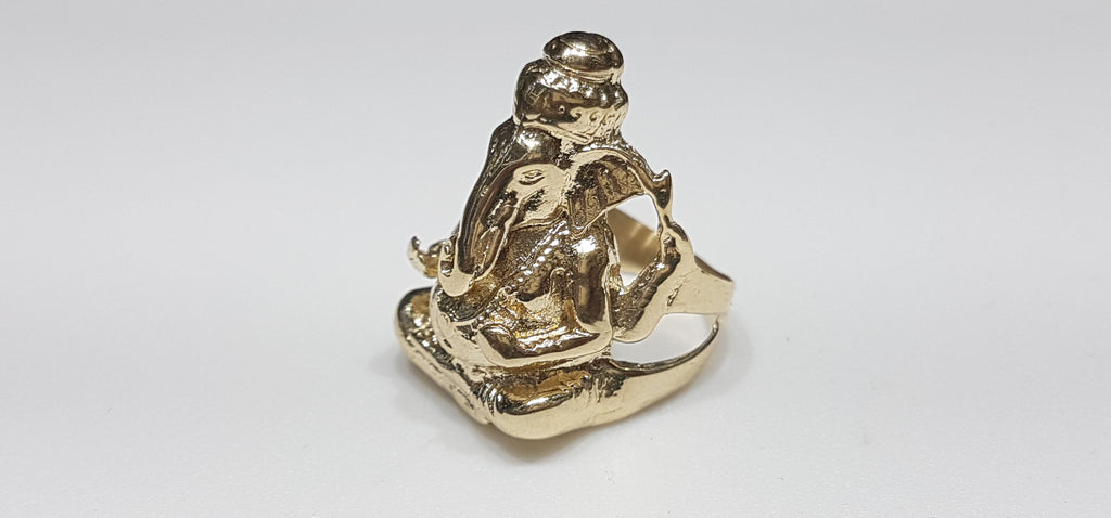 In the center: a custom made Ganesha ring in 14 karat yellow gold high polish finish made by Popular Jewelry in New York City