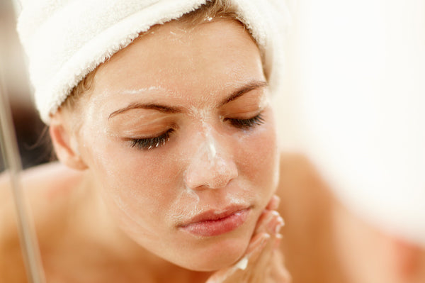 Woman exfoliating her face