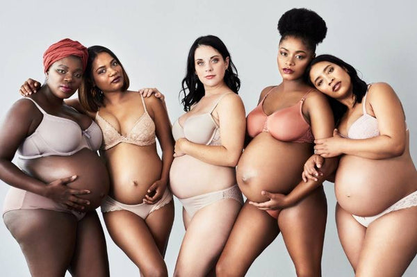 A group of pregnant women monochromatic nude clothing