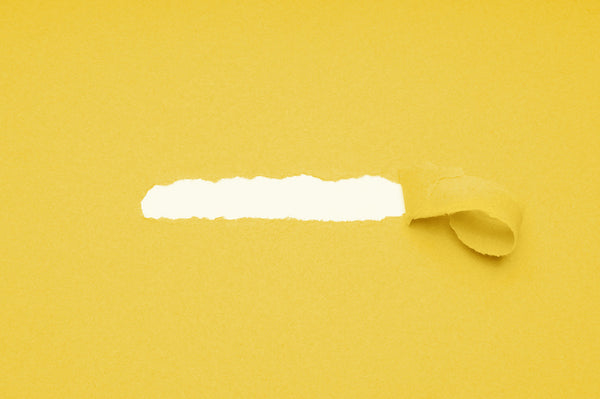 Piece of yellow construction paper torn off