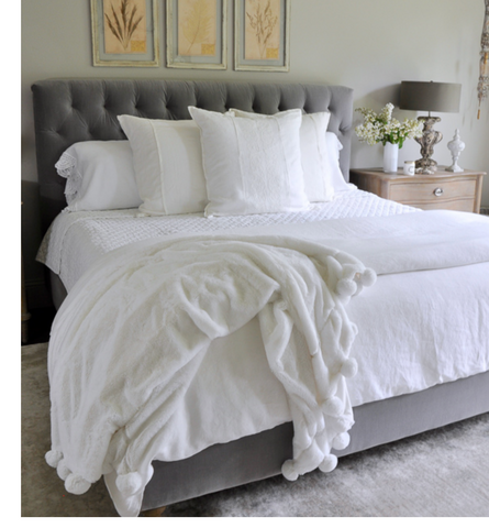 All white bed with grey headboard