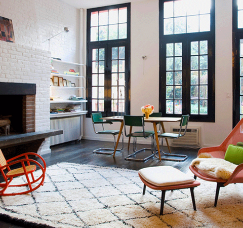 living room with large windows and a white brick fire place